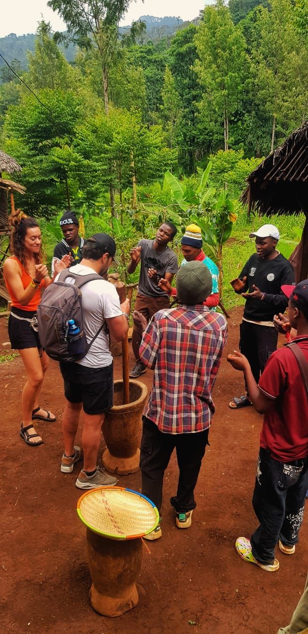 Guests and hosts singing and clapping around the mortar